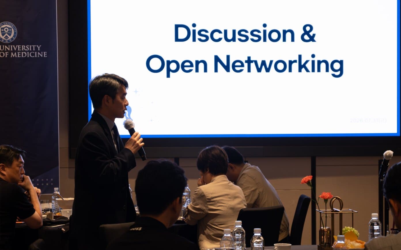 An attendee speaking during open discussion after the presentations